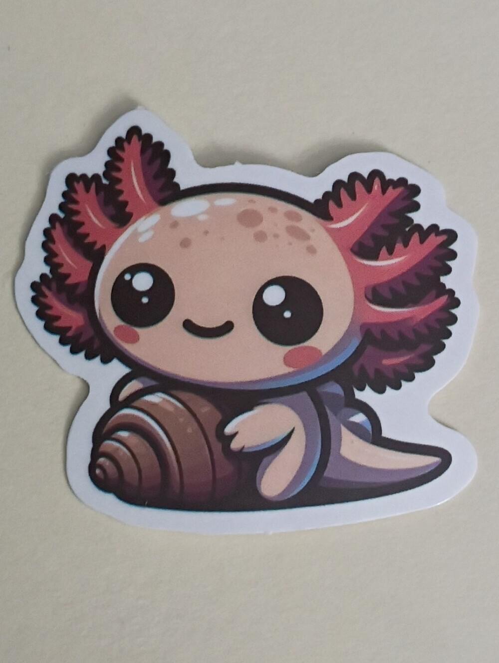 10/$10 Sticker - Pink Axolotl Peachy Cream Color Holding Brown Clam Seashell